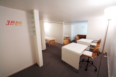 Spa rooms include massage tables and manicure stations.