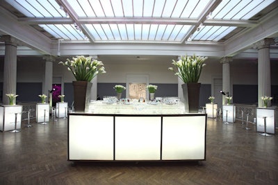 In the upstairs lounge was a glowing bar with matching tables, acrylic bar stools, and massive arrangements of calla lilies in bronze pots.