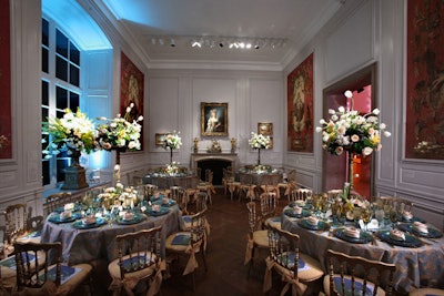 The Little Mantle Room matched its Rococo art with blue and gold paisley linens, gold opera chairs, and gilded pedestals for the floral arrangements.