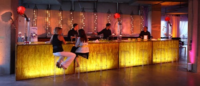 At a Lucite tortoise-shell bar backed by a wall of votive candles, bartenders poured Champagne cocktails garnished with fresh berries and edible flowers.