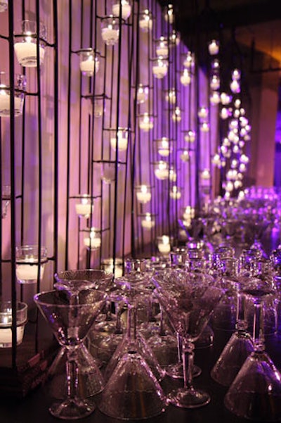 André Wells put a wall of votive candles on metal stands behind one of the two bars.