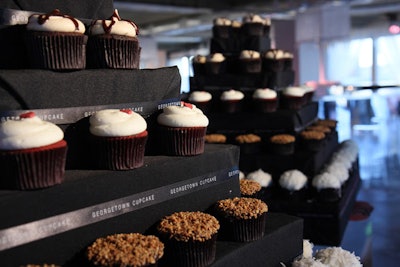 For a dessert display, Georgetown Cupcake constructed two five-tier towers, each wrapped with a logo ribbon.