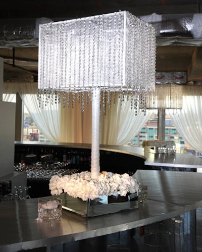 Hanging crystals draped satin-wrapped lamps on one of the two bars.