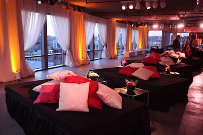 One seating area comprised double beds covered in black silk and topped with a collection of fuzzy pink and white sequined pillows.