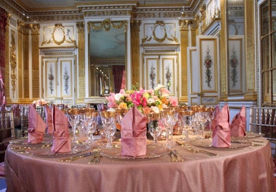 The Salon d'Ore setup continued the space's ornate feel with gold-trimmed glasses, gold sheers over rose shantung linens, and low centerpieces of pink roses and white calla lilies.