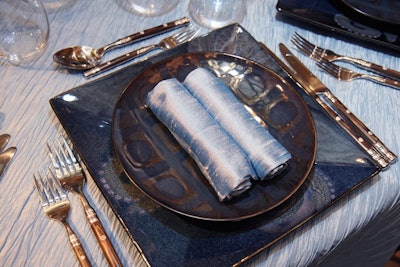 Another Atrium table paired ice blue linens with square- and dot-patterned plates in marine blue and brown.