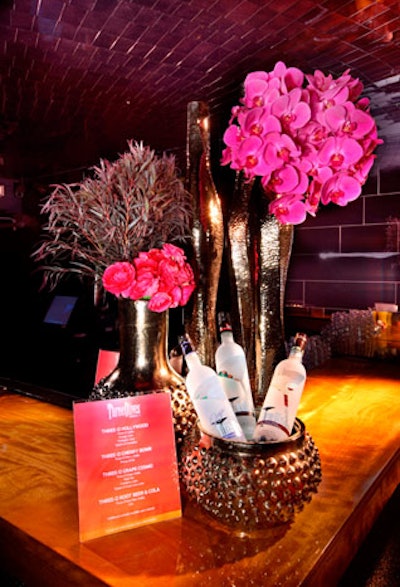 Decor included arrangements of fuchsia and black foliage in contemporary vases.