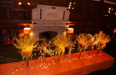 The wood-paneled reading room included a banquet table where Spot Floral Design placed four arrangements mixed with metal tree sculptures that included hanging votives.