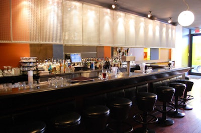 3rd Uncle Design created a '60s feel in the space—and used reclaimed bowling alley planks to top the bar.