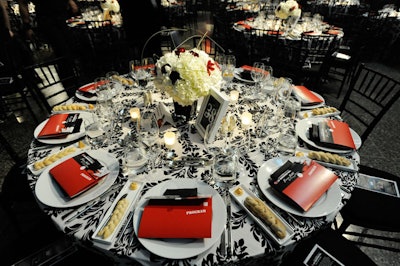 Solutions With Impact topped the dining tables with black and white linens from Around the Table and centrepieces from San Remo Florist.