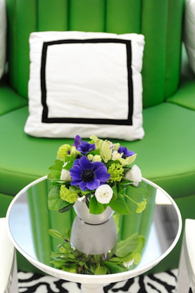 Small floral arrangements topped mirrored tables in the cocktail lounge.