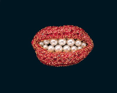 The exhibit features works by Salvador Dali, including a piece called the 'Ruby Lips' brooch (1949).