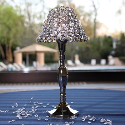 Small lights decorated with faux diamonds topped tables in the auction area.