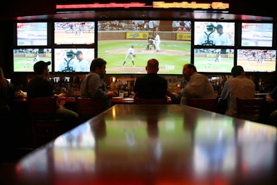 The video wall behind the bar has continual sports programming and up-to-date stock prices.