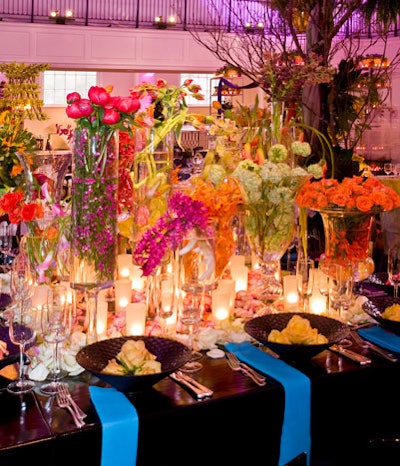 David Beahm put together a sleek and colorful garden for the center of his table, using an array of flower-filled glass containers.