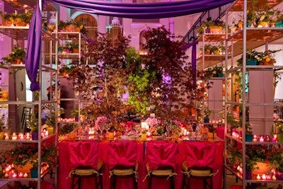 Susan Edgar of Flowers, Sticks, and Stones mixed live trees and potted flowers with faux birds, hemmed in by four towering shelves filled with plants to create a sumptuous garden setting.