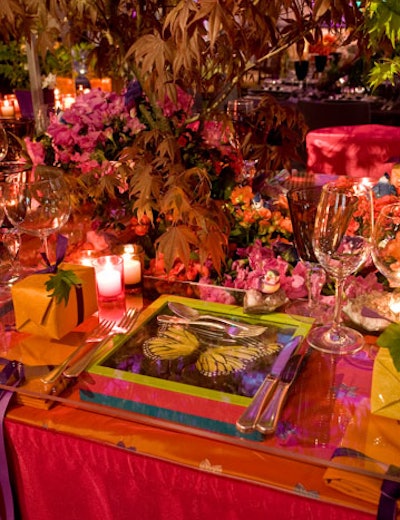 Shadowboxes filled with different nature scenes supported the clear tabletop at Susan Edgar's dining space and acted as chargers for each place setting.