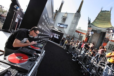 A DJ spun tunes along the black carpet.