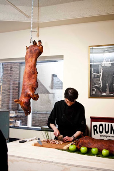Organizers hung a roast pig, complete with head and hooves, from a hook above the carving station.