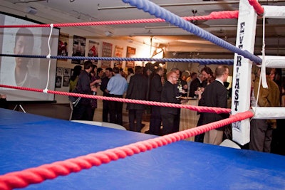 A boxing ring sits in the middle of the gym.