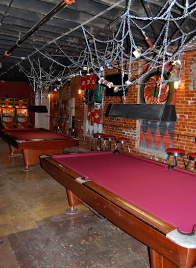 The ground-level bar and lounge has two pool tables, two shuffleboard tables, two ski-ball machines, and an open kitchen.