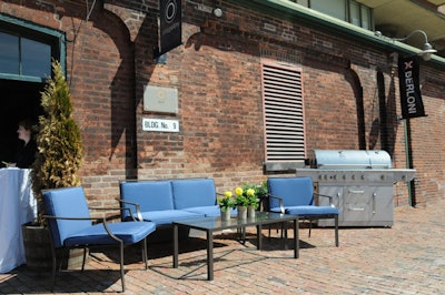 Organizers used brightly coloured patio furniture and a barbecue to create a welcome area outside the Arta Gallery.