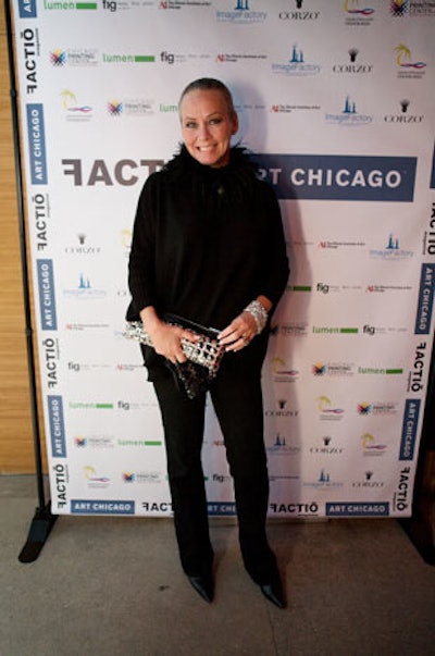 Guests, including Candace Jordan of the host committee, posed in front of a step-and-repeat splashed with sponsor logos.