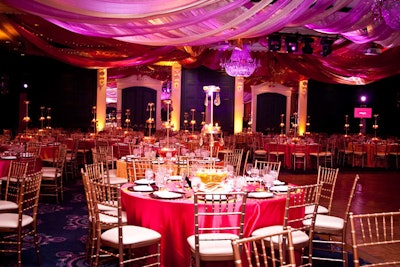 Organizers draped panels of fabric from the ceiling and filled the dining room with pink and orange lighting.