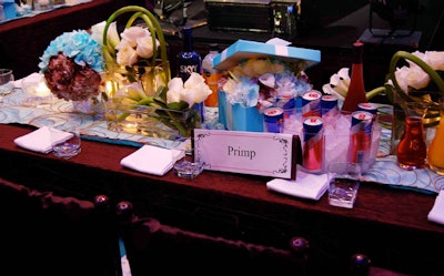 Square glass vases of varying heights and blue Tiffany & Company boxes filled with bent white calla lilies served as centerpieces on the V.I.P. tables.