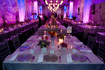 In the three dining rooms on the center's upper level, floral arrangements of pink roses, fuchsia peonies, and lilacs in square silver boxes and tall cylindrical glass vases lent a romantic air.