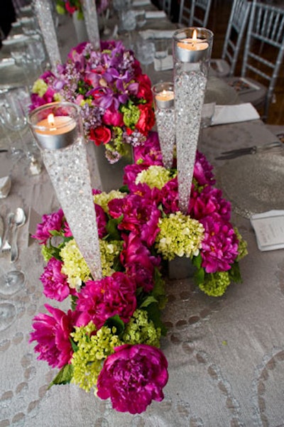 Some tables were topped by glass votives filled with clear crystals.
