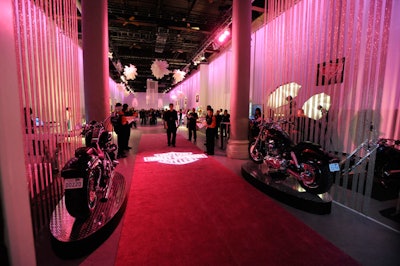 Two Harley-Davidsons flanked either side of the pink carpet at the entrance to the event.