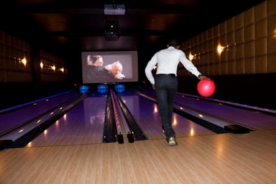 The four bowling lanes in the lounge were open to guests, and Conair used the 22- by 12-foot screen at the rear to project a video presentation.