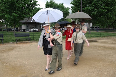 Volunteer Boy Scouts with umbrellas walked guests to and from their cars.