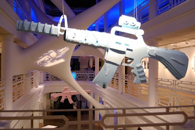 Three oversized machine gun art installations by Canadian artist Bob Parrington, ranging in size from four to eight feet, hung from the ceiling in the atrium.