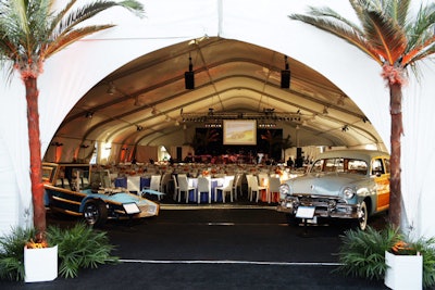 Palm trees and vintage cars lined the entrance to the dining tent.