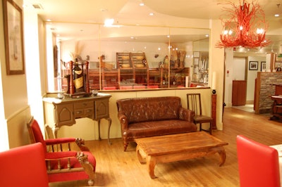 A vintage leather sofa provides seating near the bar.