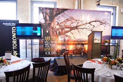 A poster bearing the image of an Australian landscape served as a backdrop for the stage.