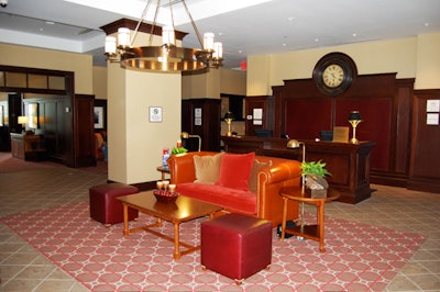 The lobby features dark wood paneling and leather-like furniture.