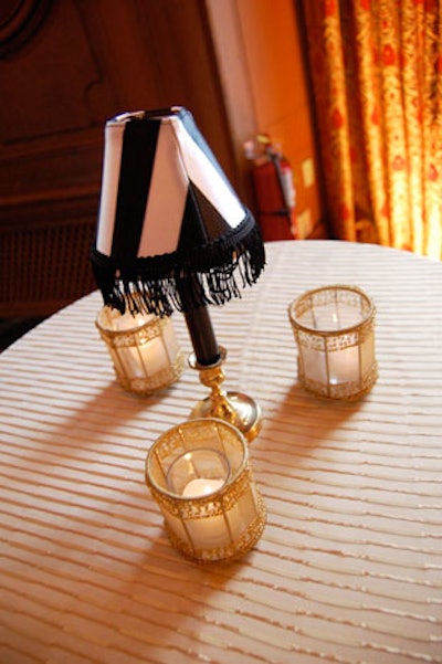 Striped lamps and embroidered candleholders decorated highboys.