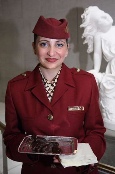 On the stairs leading up to the Qatar lounge, stewardesses offered dates on silver platters.