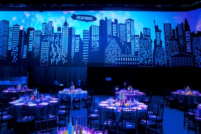 Printed with a silhouette of the city skyline, a large scrim enveloped the dinner space.