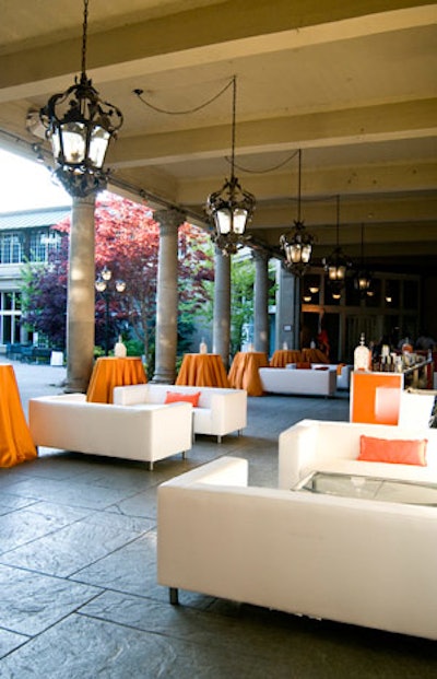 White sofas topped with orange pillows created a lounge in the courtyard.