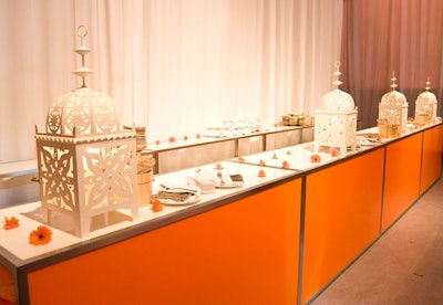 Moroccan-style lanterns and orange gerbera daisies topped a food station in the Artifacts Room.