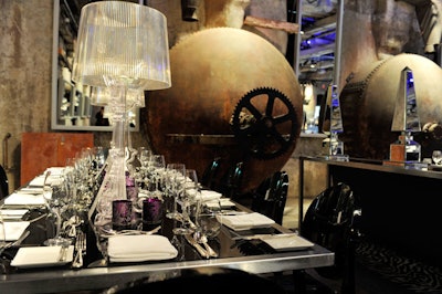 Bourgie table lamps—designed for Kartell by Ferruccio Laviani—and purple votive holders topped tables for the dinner.