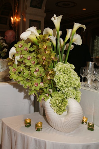 Art Deco-ish ceramic nautilus shells held floral arrangements by Andrew Pascoe Flowers.