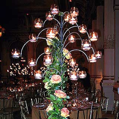 Twenty-four votive candles in glass containers were suspended on the branches of each tree