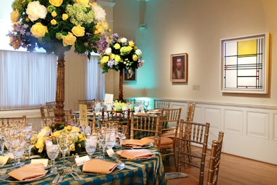 Blue and gold checkered linens dressed tables in one gallery, influenced by a Mondrian painting.