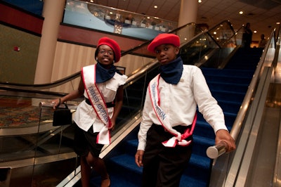 Child volunteers in red berets welcomed guests to the gala.