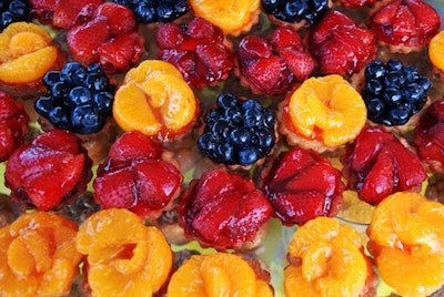 Barton G. served blueberry, strawberry, and mandarin orange tartlets—among many desserts—at themed stations.